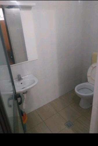 a bathroom with a sink and a toilet at Ajsi Apartments in Durrës