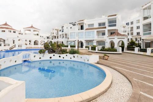a large swimming pool in front of some buildings at Sea view Tamaris Dar Bouazza in Tamaris