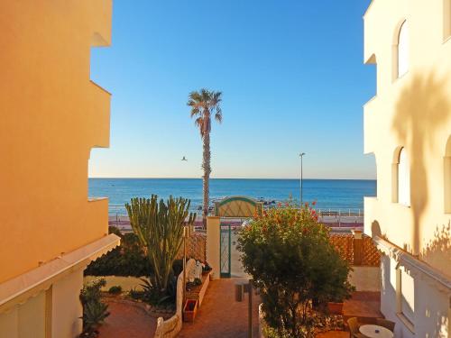 a view of the beach from the balcony of a building at Hotel Kaly in Ventimiglia