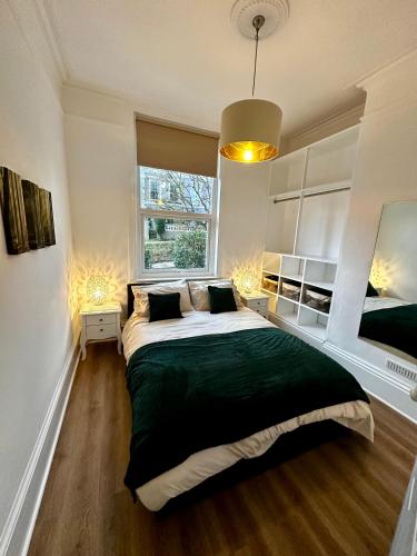 a bedroom with a large bed and a window at The Look-out! Park Hills Beach in Hastings