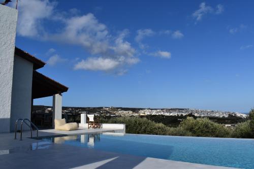 a swimming pool with a view of the city at Villa Thea sitia in Sitia