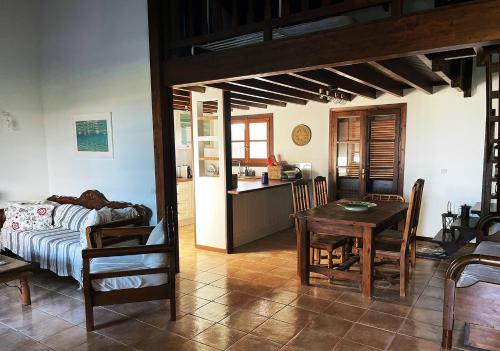 a living room with a table and a kitchen at Villa Thea sitia in Sitia