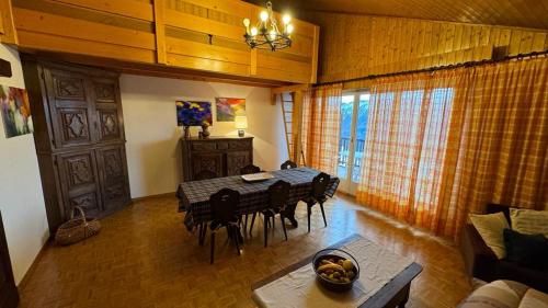 a dining room with a table and chairs in a room at Crans Montana spacious 80m2 apartment with stunning view & bus stop outside in Crans-Montana