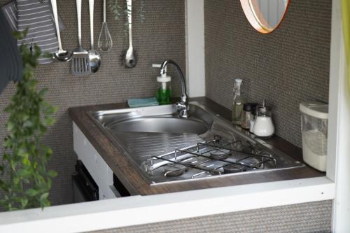 a kitchen counter with a sink and a stove at Floss Priepert 1 in Priepert