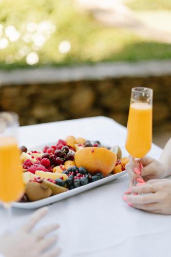 a plate of fruit and a glass of orange juice at La Roche Estate in Franschhoek
