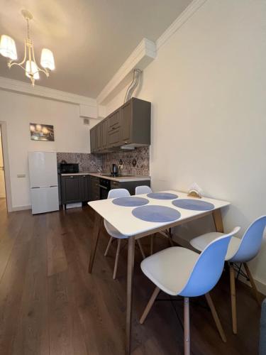 a kitchen with a table and chairs in a room at ЖК GAGARIN PARK Comfort in Almaty