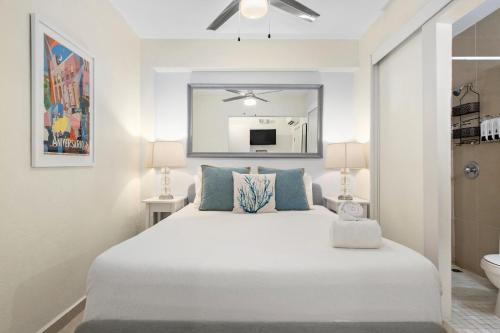 a bedroom with a large white bed and a bathroom at Prime Location at Condado Beach 1br 1ba - Apt 8 in San Juan