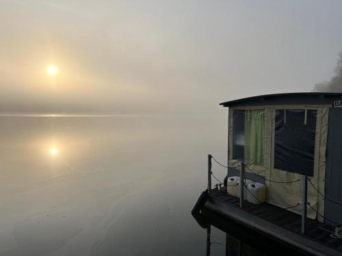 a boat sitting on the beach in the fog at Floss Priepert 1 in Priepert
