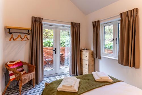 a bedroom with a bed and a window at Kestrel Cottage at Seven Sisters Country Park in West Dean