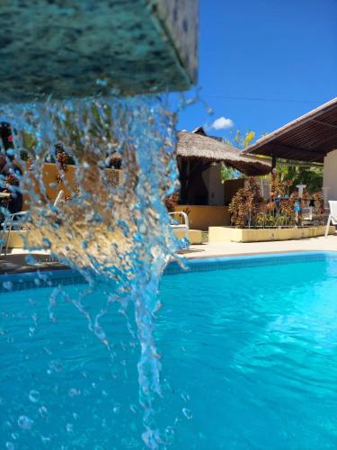 a splash of water in a swimming pool at Pousada Flor de Lótus Suites Carneiros in Tamandaré