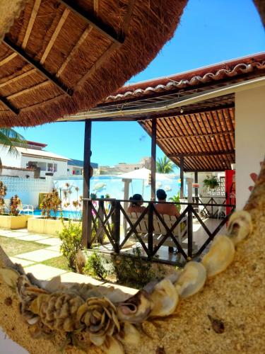 a view of the ocean from a resort with a beach at Pousada Flor de Lótus Suites Carneiros in Tamandaré