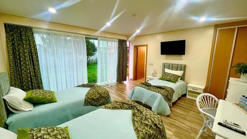 a hotel room with two beds and a television at A Fonte in Estarreja