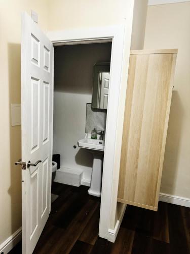 a bathroom with a toilet and a mirror at Nice and Pleasant in Thornton Heath