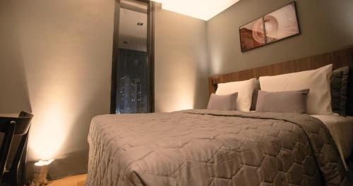 a bedroom with a large bed with a window at Nord One in João Pessoa