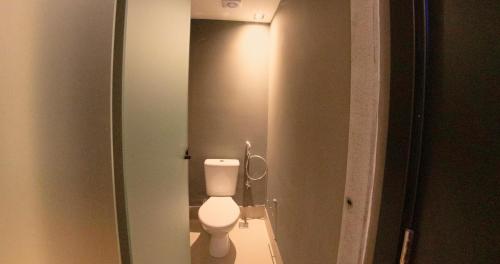 a bathroom with a white toilet in a stall at Nord One in João Pessoa