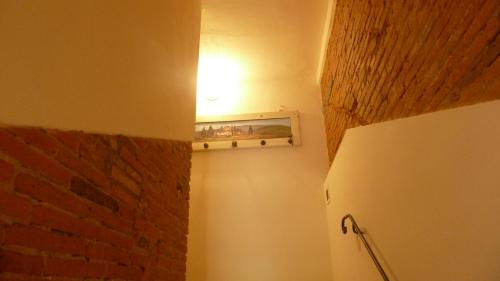 a room with a refrigerator and a brick wall at Al Vecchio Leccio in Pistoia