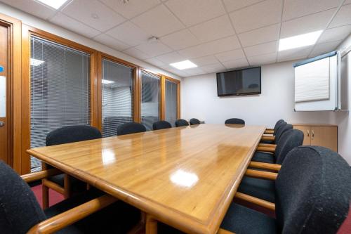 a conference room with a large wooden table and chairs at For Student Only City Living Studios in the heart of Coventry at Market Way in Coventry