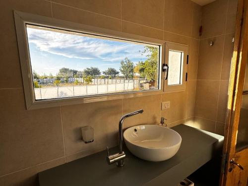 a bathroom with a sink and a window at Estancia TATAY in Trelew