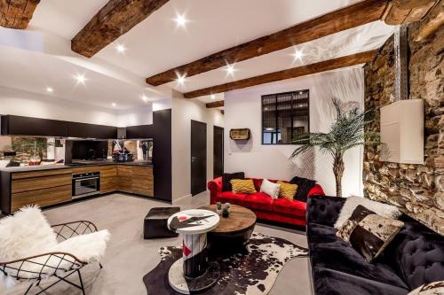 salon z czerwoną kanapą i kuchnią w obiekcie Le Saint-Georges w mieście Lyon