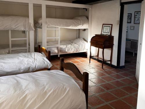 a room with three bunk beds and a desk at Estancia TATAY in Trelew