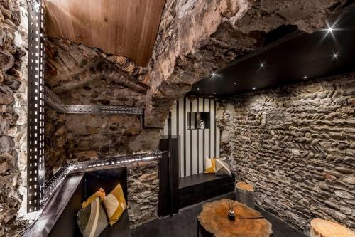 a room with a stone wall with a fireplace at Le Saint-Georges in Lyon