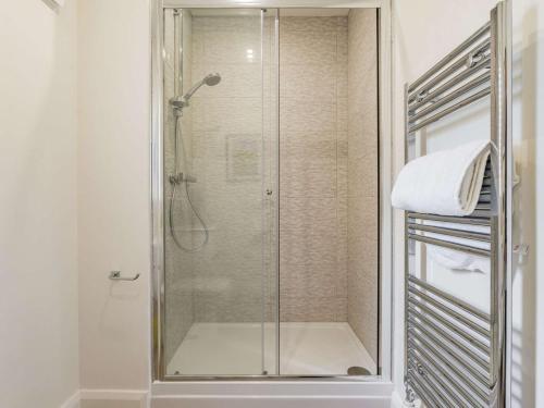 a shower with a glass door in a bathroom at 3 Bed in Hackthorpe 86724 in Hackthorpe