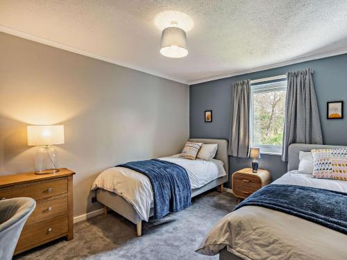 a bedroom with two beds and a window at 2 Bed in Keswick 87092 in Keswick