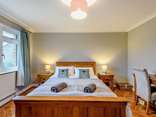a bedroom with a large bed with two pillows on it at 3 Bed in Corfe Castle 86239 in Corfe Castle