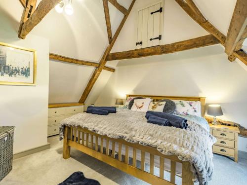 a bedroom with a king sized bed and wooden beams at 3 Bed in Wroxham 86387 in Swanton Abbot