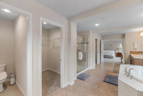 a bathroom with a sink and a toilet and a bedroom at Serenity Shores in Kenmore in Kenmore