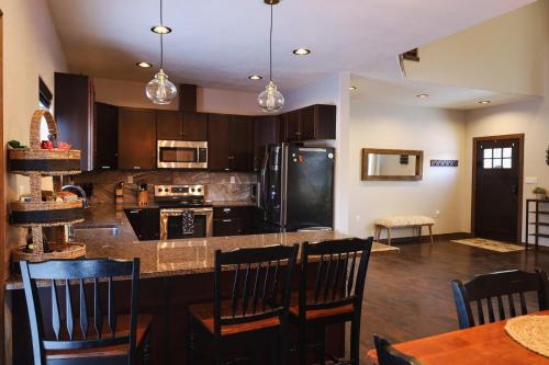 a kitchen with a island with chairs and a table at Lepista Landing Family Home Near Downtown KFalls in Klamath Falls