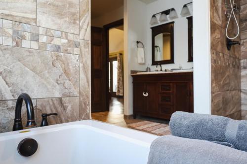 a bathroom with a bath tub and a sink at Lepista Landing Family Home Near Downtown KFalls in Klamath Falls