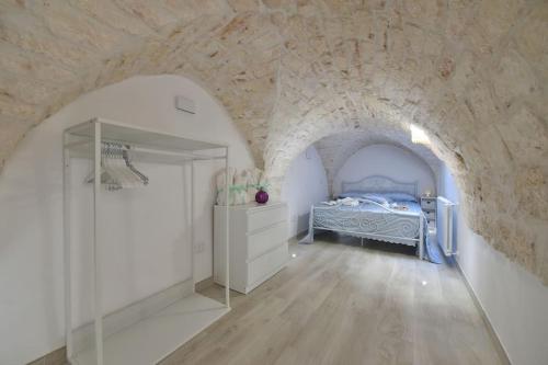 A bed or beds in a room at Le Alcove del Leopardi