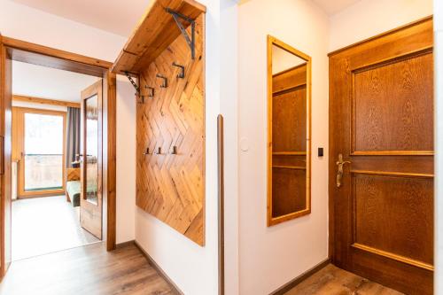 a hallway with a door and wooden walls at Apartment Gästehaus Luggau in Rauris