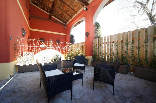 a patio with chairs and a table with christmas lights at BolognaRoomscom - Ca' Palazzo in Sasso Marconi