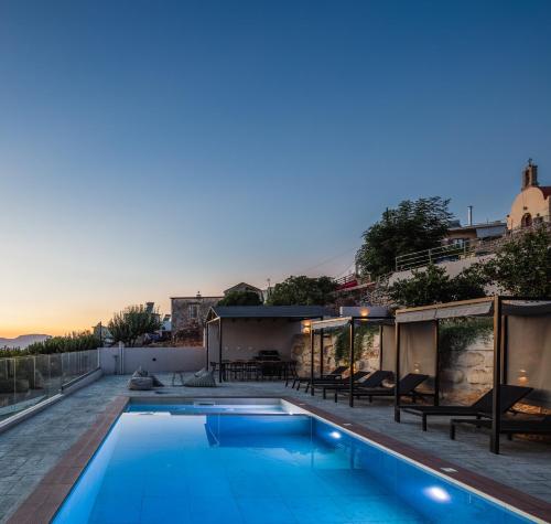 a swimming pool on the roof of a house at Suites Olive Tree Farm Episkopi Village in Episkopí- Rethimno