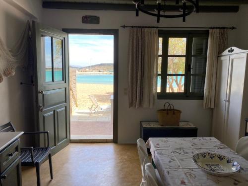 a room with a table and a view of the beach at Fishermen Beach House in Dhiakofti