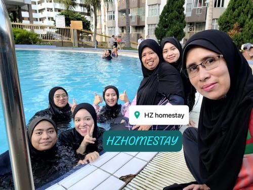 a group of women are standing in a swimming pool at Ocean view resort homestay near beach free wifi,cucckoo 3ROOM in Port Dickson