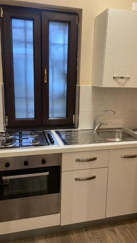 a kitchen with a sink and a stove at Nonna Concetta B&B Nocera - Vicino Tribunale di Nocera - Ristrutturato 2022 in Nocera Inferiore