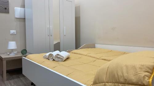 a bed with two pairs of shoes sitting on it at Nonna Concetta B&B Nocera - Vicino Tribunale di Nocera - Ristrutturato 2022 in Nocera Inferiore