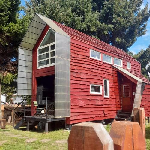 a red shed with a window on top of it at Mapunre in Malalcahuello