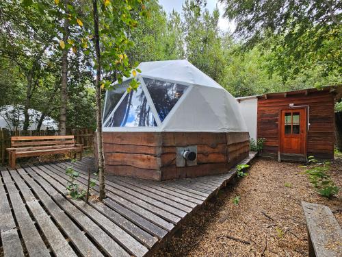 a large tent sitting on a wooden deck at Vortice Chile Eco-Lodge in Manzanar
