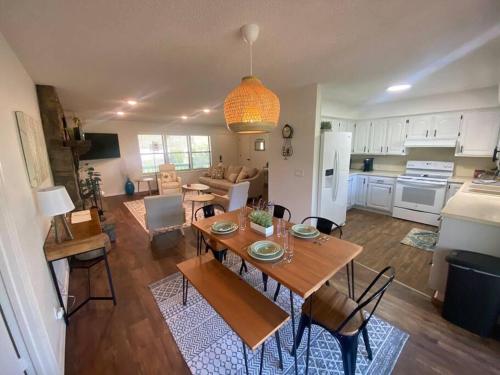 a kitchen and living room with a table and chairs at Secluded Lakeview retreat by Eureka Springs-CANOE in Eureka Springs