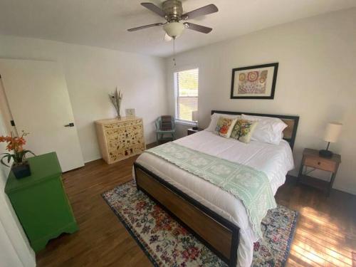 a bedroom with a bed and a ceiling fan at Secluded Lakeview retreat by Eureka Springs-CANOE in Eureka Springs