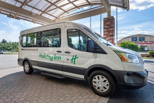 a small white van parked under a building at Holiday Inn Bangor by IHG in Bangor