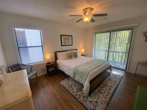 a bedroom with a bed and a ceiling fan at Secluded Lakeview retreat by Eureka Springs-CANOE in Eureka Springs