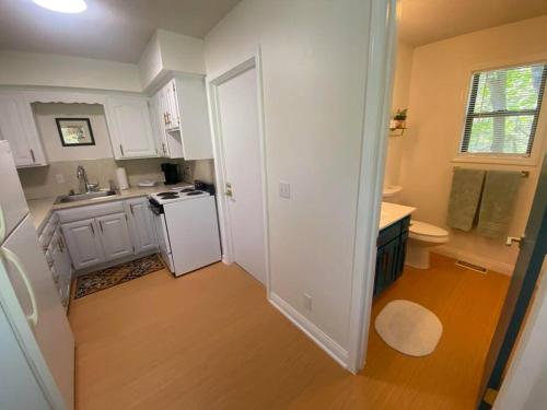 a kitchen with white cabinets and a white refrigerator at Secluded Lakeview retreat by Eureka Springs-CANOE in Eureka Springs
