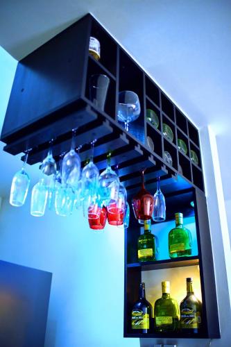 a cabinet filled with lots of glass bottles at Apartamentos Amoblados Confort Turismo en Cúcuta in Cúcuta