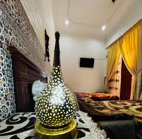 a vase sitting on a table in a bedroom at Dar Al Fassia in Oujda