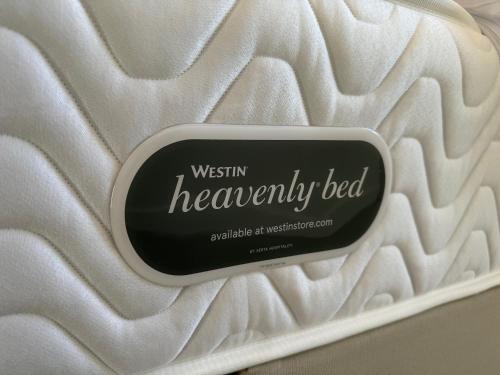 a sign that says western heavenly bed on a white blanket at CIRCLE OF 2 in Belgrade